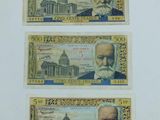 trois billets de banque différents sur lesquels figure l'image d'un homme barbu