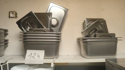 many pans and pans on the shelves in the kitchen