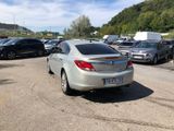 a silver car parked in a parking lot next to other cars