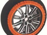 an orange and black tire cover with a black rim on a white background