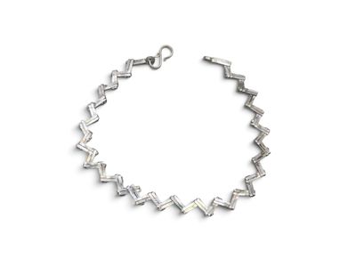 silver bracelet with square cut crystals on a white background