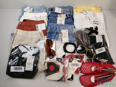 a lot of clothing and accessories laid out on a table
