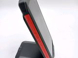 a cell phone that is sitting on top of a stand