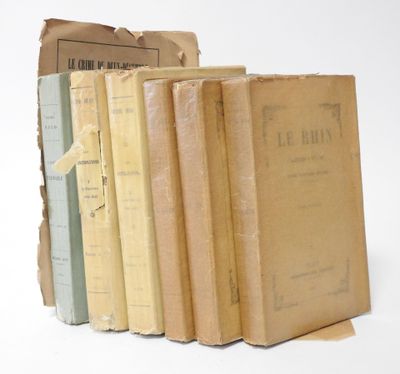 several old books stacked on top of each other on a white surface
