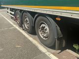 a green and yellow semi truck parked on the side of the road