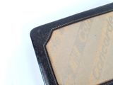 a black wallet with a picture on it sitting on a white surface
