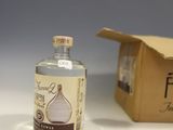 a bottle of alcohol sitting next to a cardboard box
