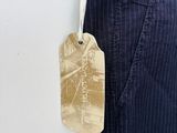a tag hanging on the back of a man ' s pants