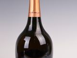 a close up of a bottle of champagne on a white surface