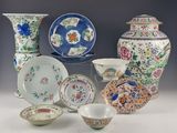 many different types of porcelain dishes and bowls on display