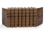 une pile de cinq livres posés les uns sur les autres sur une surface blanche