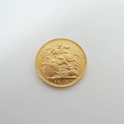 an image of a gold sovereign coin on a white surface