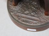 a bronze statue of a dog on a table