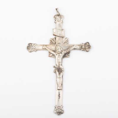 an antique silver crucif cross with a crown on it