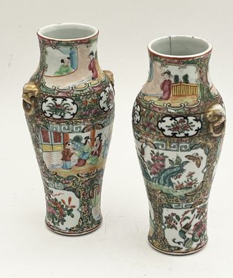 two vases sitting side by side on a white surface