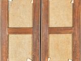 pair of antique wooden shutters with burlock cloth panels
