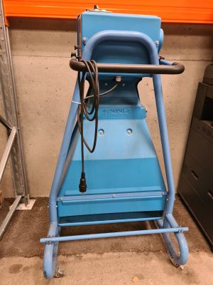 a blue machine that is sitting in a garage