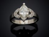 a close up of a diamond ring on a black surface