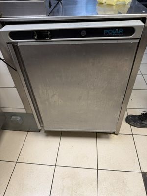 a silver dishwasher sitting in the middle of a kitchen