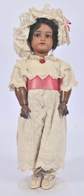 a small doll that is wearing a dress and a hat