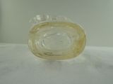 a clear glass object on a white surface