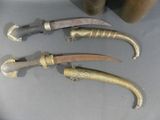 three knives that are sitting on a table