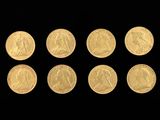 six gold coins are arranged in a row on a black background
