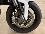 a close up of a motorcycle tire on a concrete surface