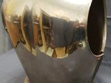 a silver vase that is sitting on a table