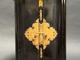 a black and gold box with a gold cross on it
