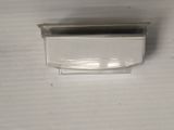 a glass container with a black lid on a white surface