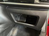 the interior of a car with the door open and the dash light on