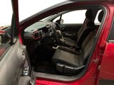 the interior of a red car with the door open