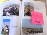 an open book with a pink post it note on it
