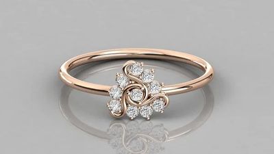 a rose gold engagement ring with diamonds on top