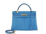 a blue leather handbag with gold hardware