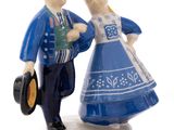 two figurines of a man and a woman dressed in blue