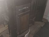 a stove that is sitting on a pallet in a room