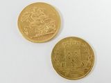 two gold coins on a white surface, one of which has a picture of a man on a horse