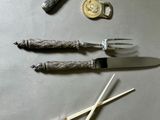 a knife, fork, and knife rest on a table