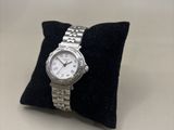 an image of a watch sitting on top of a pillow on a table