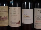 several bottles of wine are lined up on a shelf