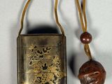 an old metal case with a wooden bead on a string