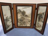 three framed asian paintings of a mountain scene on a table