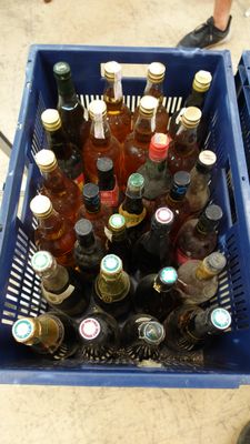 many bottles of beer in a blue basket