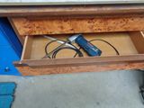 a tool in the drawer of a workbench in the garage