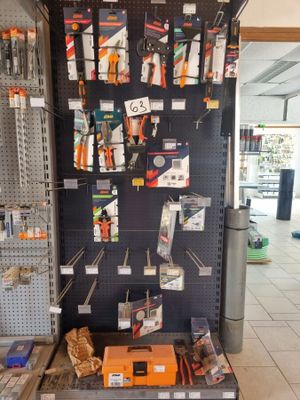 a large display of tools on the wall in a store