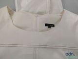 a close up of a white jacket with a black label on it