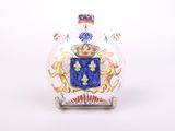 a glass vase with a coat of arms on it