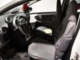 the interior of a small car with two seats and a steering wheel